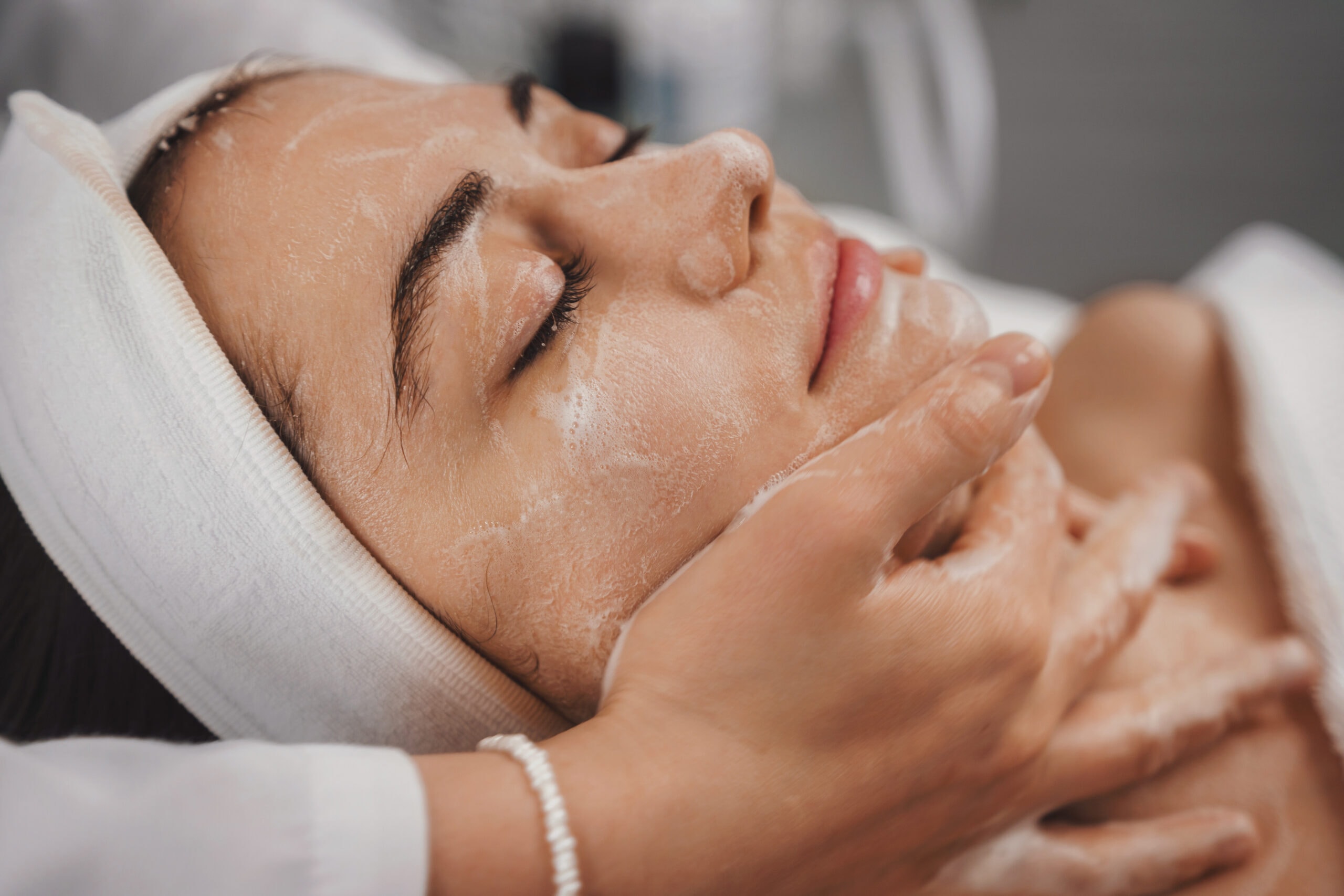 Peppermint facial spa treatment — woman receiving a relaxing facial massage